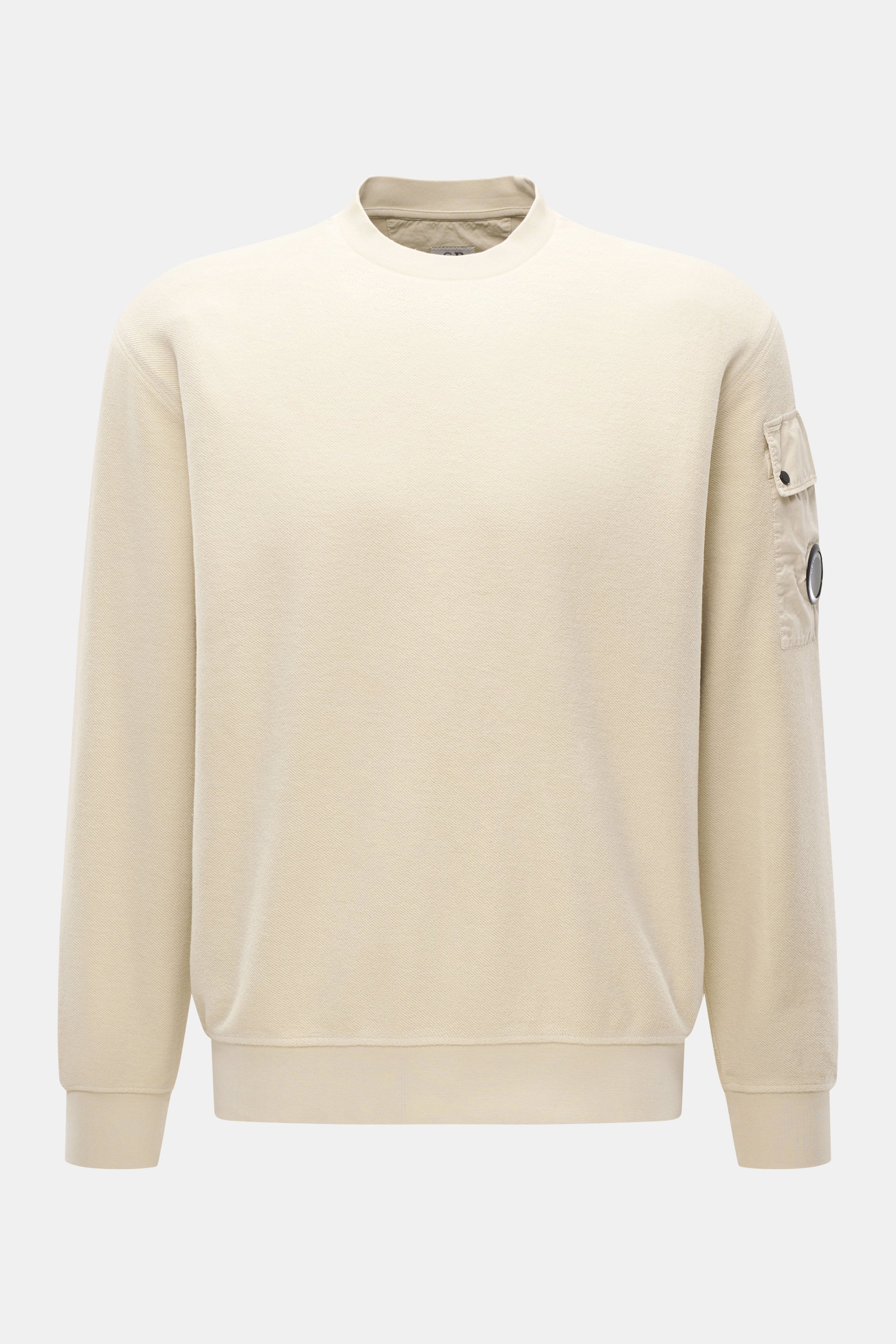Front view of C.P. Company Sweatshirt sand, an inside-out pure cotton sweatshirt with crew neckline, upper arm pocket, lens detail, and ribbed cuffs, showing its soft touch and regular fit.

Description: <p>Already from the first wear, you can feel the li