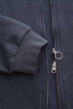 Close-up front view of the 04651/ A trip in a bag Sweat jacket 'CL Bomber' navy showing the sleeve cuff and robust two-way zip with ring pull.

<p>Relaxation on the move: The sweat jacket 'CL Bomber' by 04651/ A TRIP IN A BAG combines comfort with a high-