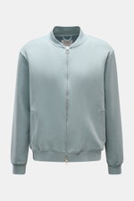 Front view of the 04651/ A trip in a bag Sweatjacke 'CL Bomber' rauchblau, featuring a garment-dyed finish, oversized fit, robust two-way zipper, typical blouson collar, slanted welt pockets, soft organic cotton and linen blend, small woven label, and fle