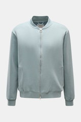 Front view of the 04651/ A trip in a bag Sweatjacke 'CL Bomber' rauchblau, featuring a garment-dyed finish, oversized fit, robust two-way zipper, typical blouson collar, slanted welt pockets, soft organic cotton and linen blend, small woven label, and fle