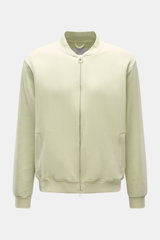 Front view of the 04651/ A trip in a bag Sweatjacke 'CL Bomber' pastellgrün, a pastel green oversized bomber jacket with garment-dyed organic cotton and linen, two-way zipper, slanted pockets, ribbed cuffs, and a blouson collar.

Description: <p>Entspannt