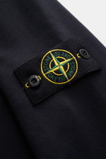 Close-up view of the Stone Island Sweatshirt Jacket Dark Navy showing the detailed embroidered compass badge on soft garment-dyed cotton fabric.

Description: <p>Relaxed basic by STONE ISLAND: With sporty casualness, the garment-dyed sweatshirt jacket mad