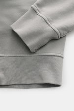 Close-up front-side view of Stone Island Hoodie grey showing ribbed cuff and hem in soft, garment-dyed pure cotton.

<p>Timeless casualwear: The hoodie by STONE ISLAND is an indispensable companion for cooler days with its versatile silhouette.</p>
<ul>
<