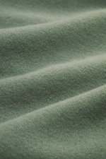 Nahaufnahme des Stoffes vom 04651/ A trip in a bag Kapuzenpullover 'CW Hoodie' salbei, Mix aus Wolle und Baumwolle, weicher Griff, Regular Fit, Kapuze, Weblabel, Rippbündchen.