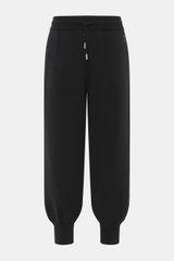 Front view of Ami Paris Merino jogpants black, made of pure merino wool with soft touch, loose fit, high elastic waistband with drawstring, side pockets, leather logo detail, and ribbed cuffs.