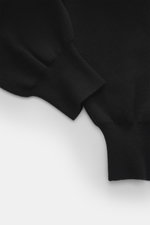 Close-up front view of Ami Paris Merino jogpants black focusing on soft-touch pure merino wool fabric, comfortable ribbed cuffs, showing loose fit, high elastic waistband with drawstring, leather logo detail, and side pockets.