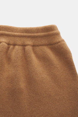 Ami Paris Merino jogpants light brown shown from a close-up top view, featuring pure merino wool, soft touch, loose fit, high elastic waistband with drawstring, leather logo detail, comfortable ribbed cuffs, and side pockets.