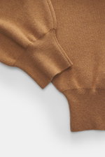 Close-up front view of Ami Paris Merino jogpants light brown showing soft touch pure merino wool fabric, loose fit, high elastic waistband with drawstring, leather logo detail, comfortable ribbed cuffs, and side pockets.