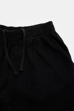 04651/ A trip in a bag Frottee-Shorts 'Terry' schwarz, von oben fotografiert, aus weichem Baumwoll-Frottee, elastischer Bund mit Tunnelzug, Taschen.