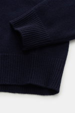 Close-up of the sleeve cuff and hem of Stone Island Half-zip jumper 'Lambswool' navy, showing fine ribbed knit in warm wool blend, photographed from above.

Description: 
<p>A stylish essential for the colder months: This timeless half-zip jumper by STONE