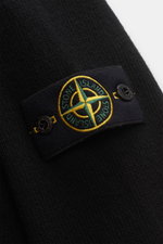 Close-up front-side view of Stone Island Half-zip jumper 'Lambswool' black showing textured knit and signature compass badge with buttons on collar.

Additional description: 
<p>A stylish essential for the colder months: This timeless half-zip jumper by S