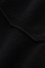 Close-up front view of Stone Island Half-zip jumper 'Lambswool' black showing medium-fine knit wool blend with embossed collar buttons and ribbed bands, featuring signature compass badge on the upper sleeve.

<p>A stylish essential for the colder months: 