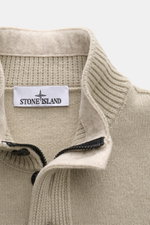 Close-up front view of Stone Island Half-zip jumper 'Lambswool' taupe showing half-zip collar with buttons, knit texture, and label. A stylish essential for the colder months: This timeless half-zip jumper by STONE ISLAND with zip and embossed buttons on 