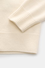 Close-up side view of the Stone Island Half-zip jumper 'Lambswool' cream sleeve and ribbed cuff, showcasing medium-fine knit wool blend.

Description:  
<p>A stylish essential for the colder months: This timeless half-zip jumper by STONE ISLAND with zip a