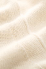 Close-up front view of Stone Island Half-zip jumper 'Lambswool' cream showing soft wool blend knitwear with medium-fine texture and ribbed bands, featuring half-zip collar with embossed buttons and signature compass badge on sleeve, perfect for cool autum