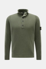 Stone Island Half-zip jumper 'Lambswool' olive shown from the front, slim fit with half-zip collar, embossed buttons, ribbed bands, and signature badge. 

A stylish essential for the colder months: This timeless half-zip jumper by STONE ISLAND with zip an
