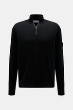 Front view of the Stone Island Troyer black quarter-zip jumper made of virgin wool and microfiber, slim fit with ribbed collar, zipper, elastic hem, compass badge on upper arm, and fine knit pattern with soft touch. Comfort meets style: The STONE ISLAND q