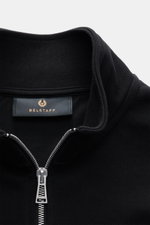 Close-up front view of Belstaff Sweat half-zip jumper 'Quarter Zip' black showing half-zip collar, BELSTAFF woven label on chest, sweat fabric made of cotton, soft feel, slim fit, and flexible ribbed bands.