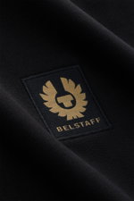 Close-up front angle of Belstaff Sweat half-zip jumper 'Quarter Zip' black showing soft cotton sweat fabric, slim fit, half-zip collar, BELSTAFF woven label on chest, and flexible ribbed bands.