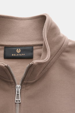 Close-up front view of the Belstaff Sweat half-zip jumper 'Quarter Zip' taupe, showing sweat fabric made of cotton, soft feel, slim fit, half-zip collar, BELSTAFF woven label on the chest, and flexible ribbed bands.