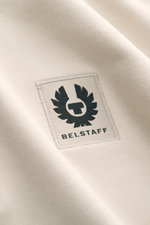 Close-up front view of Belstaff Sweat half-zip jumper 'Quarter Zip' beige, showing cotton sweat fabric, soft feel, slim fit, half-zip collar, BELSTAFF woven label on chest, and flexible ribbed bands.