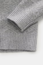 Nahaufnahme des Ärmels und Saums des 04651/ A trip in a bag Troyer 'Shadow Norwegian' grau gemustert, Slim Fit, tonales Norweger-Strickmuster, voluminöse Qualität, mittelfeines Strickbild, Mix aus Schurwolle und Cashmere, weicher Griff, komfortable Rippbü