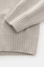 Close-up top-down view of the cuff and hem of 04651/ A trip in a bag Cashmere quarter-zip jumper 'Extreme' taupe, showing pure cashmere, very soft feel, fine knit pattern, slim fit, sweater collar with zipper, and flexible ribbed cuffs.