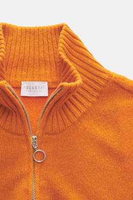 Close-up front view of 04651/ A trip in a bag Cashmere quarter-zip jumper 'Extreme' orange showing pure cashmere, very soft feel, fine knit pattern, slim fit, sweater collar with zipper, and flexible ribbed cuffs.