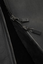 Close-up top-down view of the Emporio Armani Black sheepskin jacket showing supple lamb suede leather, lining made of sheepskin, regular fit, two-way zipper, practical hood, and side pockets.
