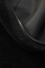 Close-up view of the Emporio Armani Black sheepskin jacket showcasing supple lamb suede leather, sheepskin lining, and a two-way zipper.