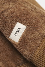 Close-up front view of the Arma Sheepskin blouson 'Arek' brown showing soft lamb velour leather, rib knit cuff, and ARMA label; when temperatures drop, you need a garment that masters both style and function – like the Sheepskin Blouson 'Arek' from ARMA. 