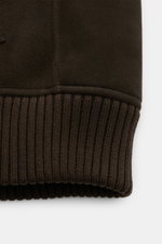 Close-up side view of the Arma Shearling blouson 'Arek' dark brown showing fine lambskin suede and elasticated ribbed bands cuff, slim fit with soft feel. When temperatures drop, this shearling blouson with a sporty cut, high-fastening ribbed collar, snap