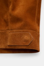 Close-up side view of Tom Ford Suede jacket brown showing finest calfskin suede texture, slim fit cuff with snap button, and adjustable waist tab.
