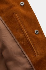 Close-up inside view of the Tom Ford Suede jacket brown, showcasing the finest calfskin suede, concealed snap button closure, glossy lining, and detailed stitching from a top-down perspective.