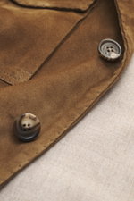 Close-up front view of the Rifugio Brown Suede Blazer showing supple suede leather, three-button style, and branded buttons.