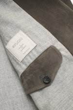 Close-up top-down view of Rifugio Suede Blazer Dark Grey showing soft suede leather cuff with button and brand label on soft virgin wool lining, highlighting its supple suede leather, soft touch, and elegant details.

Description: <p>RIFUGIO combines styl