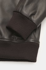 Close-up side view of the Windsor leather jacket 'Bassano' dark brown showing soft finely grained leather and knitted elastic sleeve cuff.