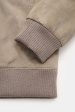 Close-up side view of the Windsor Velour leather blouson 'Borello' taupe cuff, made from soft goat velour leather with a soft feel, light padding, slim fit, stand-up collar, two-way zipper, angled welt pockets, small metal logo on the back, knitted elasti