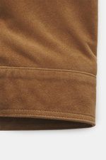 Close-up front view of the Arma Suede leather jacket 'Kale' brown, showcasing soft suede leather, slim fit, turn-down collar, two-way zipper, patch chest pockets with flap, smooth lining fabric, and two inside pockets. Stylish companion for the transition