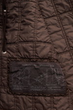 Nahaufnahme des dunkelbraunen Innenfutters mit Etikett des Stone Island Parka 'Twill Wool-TC Ghost Piece', herausnehmbar und mit veganer Primaloft-Füllung.