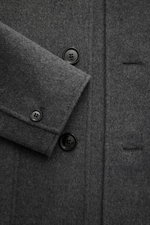 Nahaufnahme der Ami Paris Jacke grau meliert aus schräger Vogelperspektive, Slim Fit mit Schurwolle und Cashmere, weicher Griff, fünf-Knopf-Leiste, Umlegekragen, aufgesetzte Fronttaschen, Ärmelabschlüsse mit Knopf, rückwärtige Logo-Prägung, ungefüttert, e