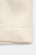 Close-up front bottom view of 04651/ A trip in a bag Woll-Overshirt 'Boiled Blouson' creme showing soft wool texture and stitching <p>Boiled Blouson</p>