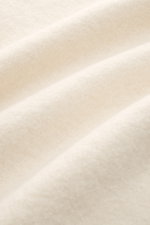 Close-up front view of soft, textured fabric of 04651/ A trip in a bag Woll-Overshirt 'Boiled Blouson' creme. <p>Boiled Blouson</p>