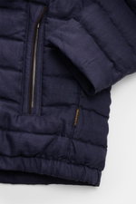 Close-up front view of Moorer Down jacket 'Alec' navy melange showing quilted pure linen fabric, two-way zip, slim fit, and zipped hip pocket with logo tag. This elegant quilted jacket 'Alec' by MOORER will see you through the changing seasons in style. T