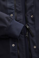 Close-up front view of Stone Island Blouson 'Light Soft Shell-R' navy, showing elastic sleeve cuff, two-way zipper, storm flap with buttons, and smooth, wind and water repellent soft shell fabric. Style meets function with high-quality microfibre, slim fi