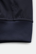 Close-up front view of the hem and sleeve cuff of the Stone Island Blouson 'Light Soft Shell-R' navy, showing high-quality microfiber with a smooth feel. Style meets function with wind and water repellent, slim fit, two-way zip, storm flap with buttons, d
