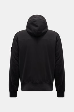 Rear view of Stone Island Blouson 'Light Soft Shell-R' black soft shell jacket with hood, elastic hem, slim fit, and compass badge on sleeve.