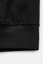Close-up side view of the elastic hem on the Stone Island Blouson 'Light Soft Shell-R' black, made of smooth, high-quality microfibre. Style meets function: This soft shell jacket by STONE ISLAND has a sporty design in three-layer functional material that