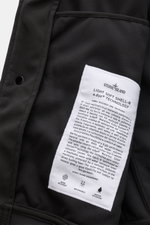 Close-up inside view of the Stone Island Blouson 'Light Soft Shell-R' black showing the detailed white label with fabric technology info. Style meets function: This soft shell jacket by STONE ISLAND has a sporty design in three-layer functional material t