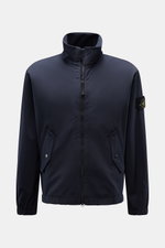 Front view of Stone Island Jacket 'Light Soft Shell-R' navy, a slim fit soft shell with standing collar, two-way zip, flap pockets, elastic cuffs, and compass badge.

<p>Style meets function: This soft shell jacket by STONE ISLAND has a sporty design in a